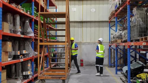 Trabalhador verifica caixas no armazém, trabalhadores do armazém verificam o inventário.