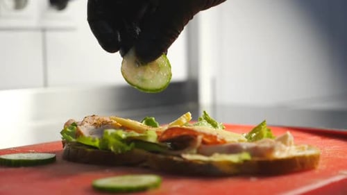 Chef Prepares Delicious Open Faced Sandwich with Cucumber
