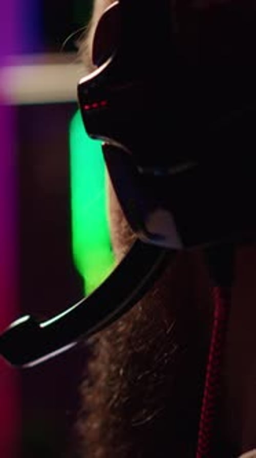 Vertical Video Gamer Battling Enemies in Multiplayer Shooter Discussing with Other Players Through