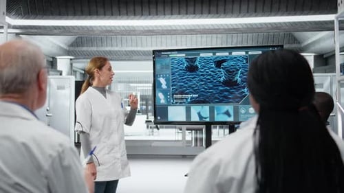 Woman Presenting Innovative Drug Development Findings to Team in Laboratory