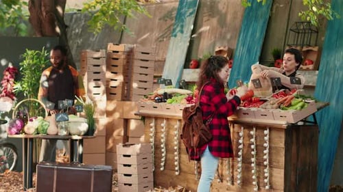 Female Stand Holder Giving Seasonal Fruits and Veggies to Customers