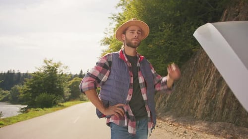 Stressed Young Bearded Guy Traveler Standing on Roadside Waiting for Help Near Opened Car Hood