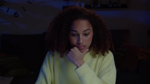 Pensive African American Teen Girl While Looking at Laptop Computer Overnight at Home Homework