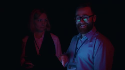 Technicians analyzing server data in modern server room