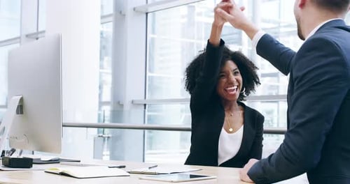 4k footage of two businesspeople celebrating their success in an office