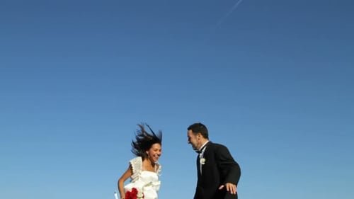 Joyful Bride and Groom Jumping with Excitement