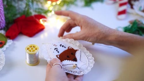 Rear View Closeup Hands of Woman Creating Christmas Decoration for New Year Tree