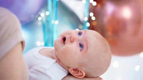 Adorable Baby Being Held, Balloons and Twinkle Lights