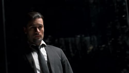 Reflection in Mirror of Man in Suit on Black Background Stock Footage Man in Suit is Preparing for