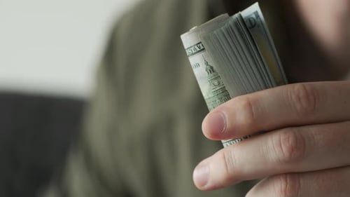 Hands Counting One Hundred Dollar Bills Close Up