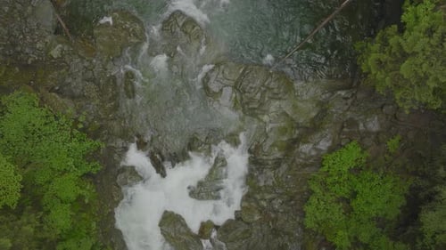 Top down pull away of a waterfall as it pools in Lynn Canyon Vancouver