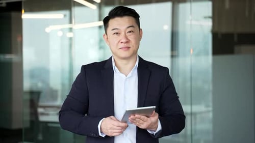 Man Uses Tablet in Modern Office Environment