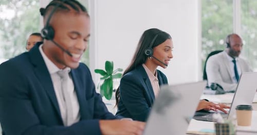 Customer Service Representatives Working in Modern Office