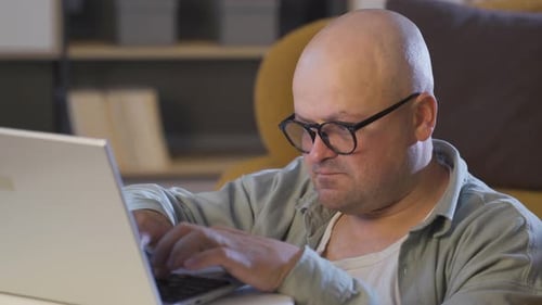 Adult Using Laptop Indoors Typing at Home