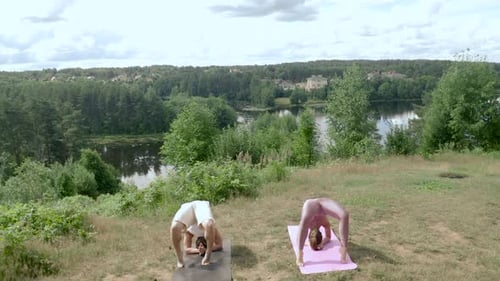 Man and Woman Doing Yoga Outdoors