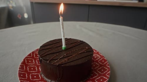Delicious Chocolate Cake with Candle on Plate Indoors