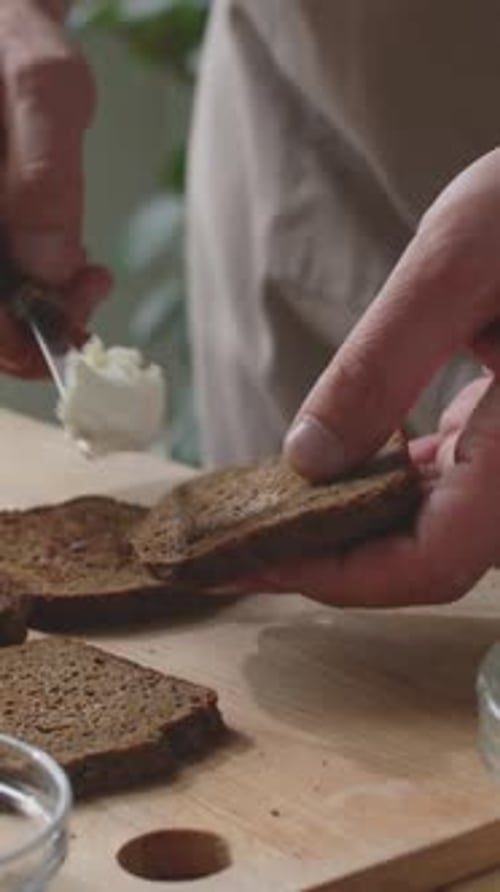 Spreading Cream Cheese on Rye Bread Slice