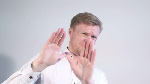 Man Gesturing Stop With His Hands in Studio