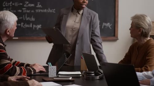Adults and Seniors Learning Computer Skills in Office