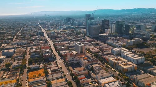 Sunny cityscape of beautiful Los Angeles, California, USA. Lots of cars moving by the streets