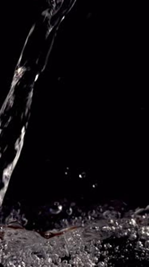 Water Pouring and Splashing on Black Background