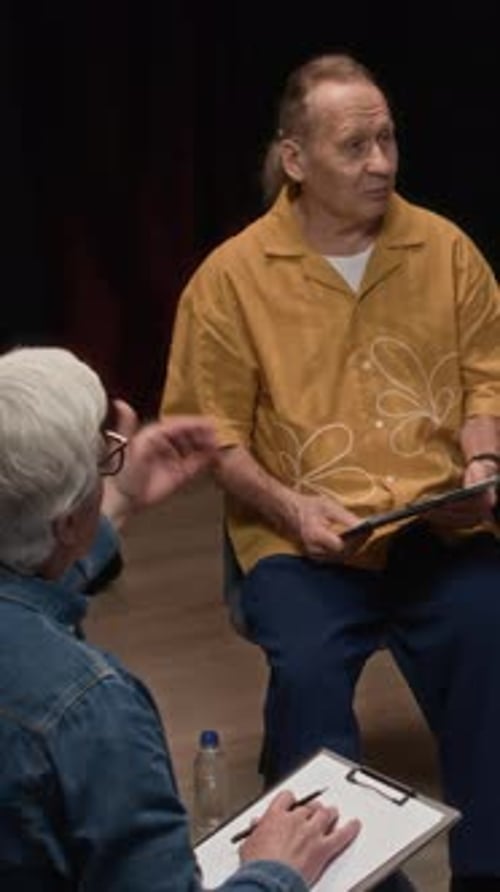 Adults Discussing Business in Dimly Lit Studio Setting