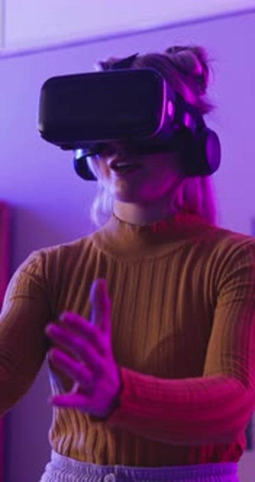 Woman Using Virtual Reality Headset in a Dark Room