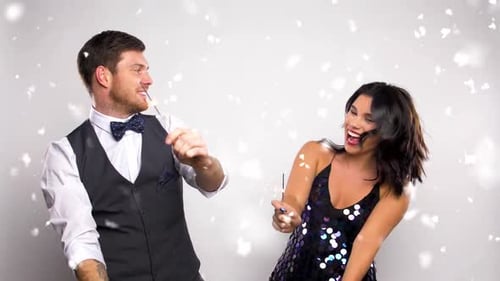 Couple Celebrates with Sparklers and Falling Confetti