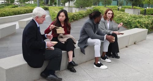 Diverse Colleagues Enjoying Lunch Break Together Outdoors