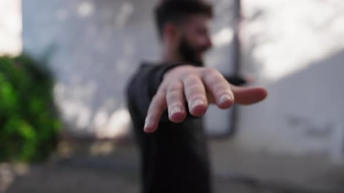 Man Waves Open Hands For Balance Exercise