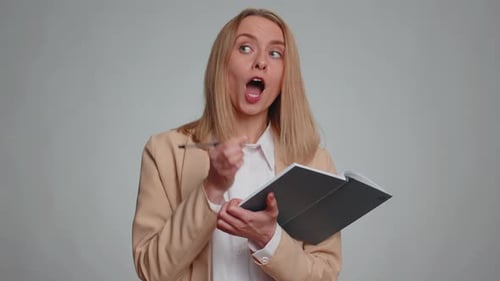 Woman Thinking and Writing Ideas in Notebook