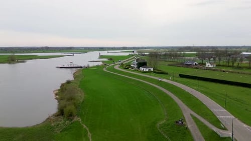 Beautiful water canal in the Netherlands. A beautiful river with a fast current. shore is covered