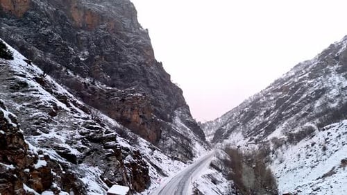 Winding Snow Road Through Mountain Range