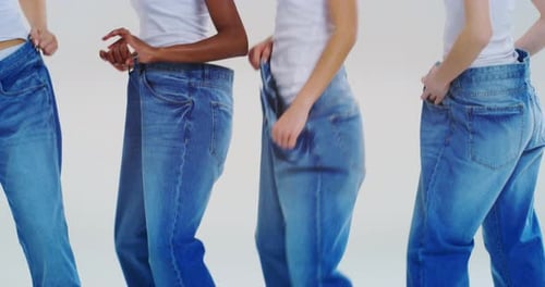 Women Displaying Weight Loss in Oversized Denim