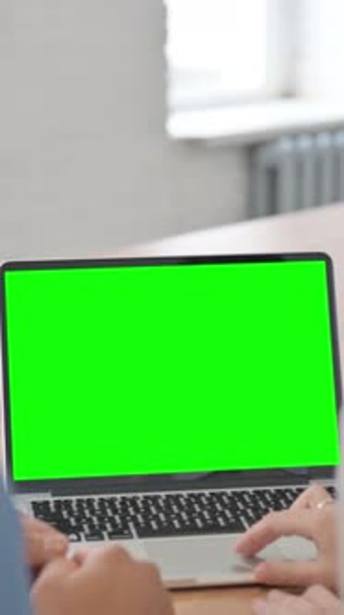 Rear View of Young People Using Laptop with Green Screen, vertical video