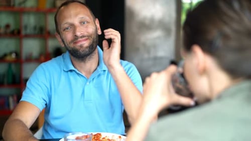 Couple Eating Lunch and Talking Indoors at Table