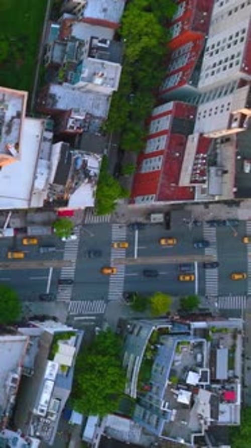 Flying over the wide-lane road and crossroads with numerous automobiles moving along.
