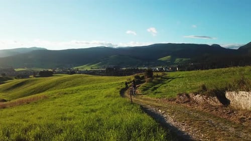 Group of friends on bicycles enjoying the view on a mountain off road bike trail. Aerial view of peo