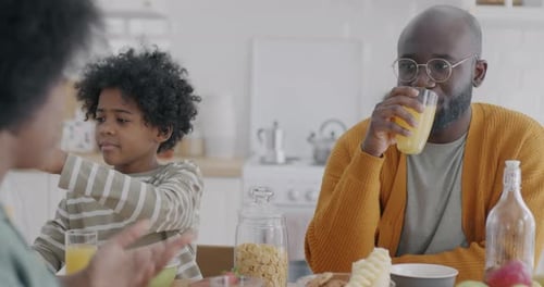 Family Breakfast at Kitchen Table in Bright Home