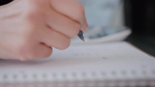 Woman Checking Bills Taxes Bank Account Balance and Calculating Expenses in the Living Room at Home