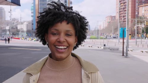 Happy Young African American Girl Smiling at Camera Standing at City Street