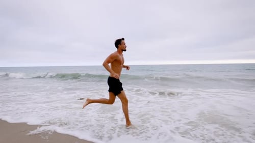 Athletic Man Exercising At The Beach