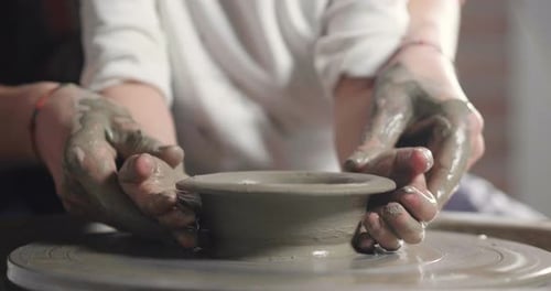 Hands Shaping Clay into Bowl on Pottery Wheel