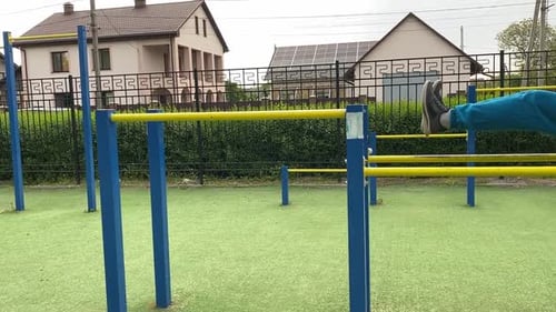 A male athlete works out at the outdoor gym