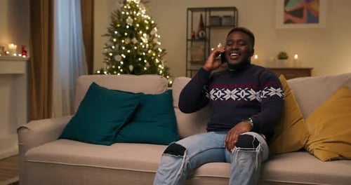 Man Talking on Phone at Christmas at Home
