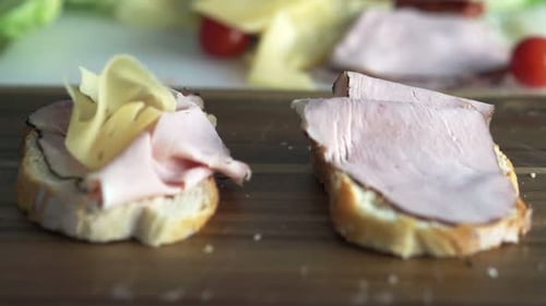 View of Cheese Falling on Sandwich with Ham on Wooden Board, Super