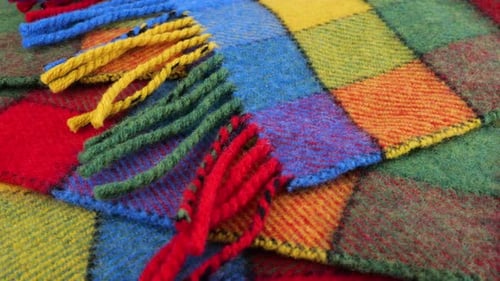 Top view on the bright textured multicolored wool fabric in a large check rotated