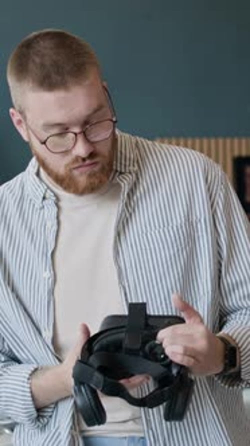 Young Caucasian Man With VR Headset In Office