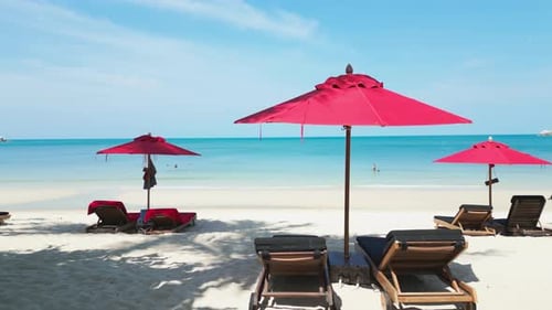 Cinematic Shot Hot Summer Day on Beach with Beach Umbrellas and Blue Sea Water The Camera Moves