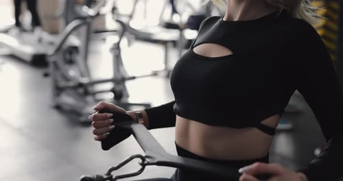 Woman Exercising at Gym on Training Apparatus